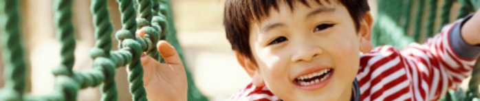 a boy smiling and pointing